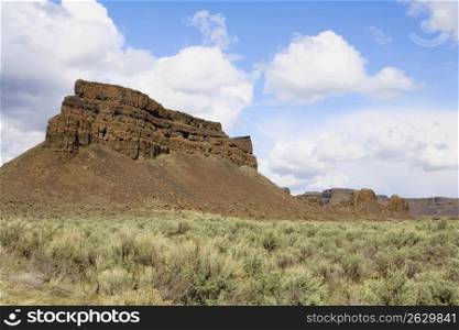 Remote rock formation in dry, scrubland landscape
