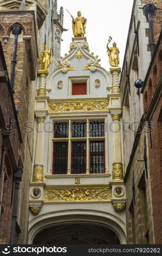 Renaissance Guilded gate, part of Aaron Civil Registry date 1543, and an entrance to Burg Square, Square. Bruges, West Flanders, Belgium, Europe