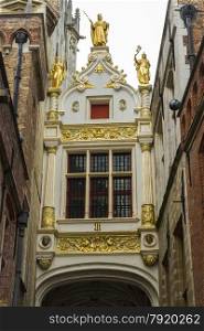 Renaissance Guilded gate, part of Aaron Civil Registry date 1543, and an entrance to Burg Square, Square. Bruges, West Flanders, Belgium, Europe