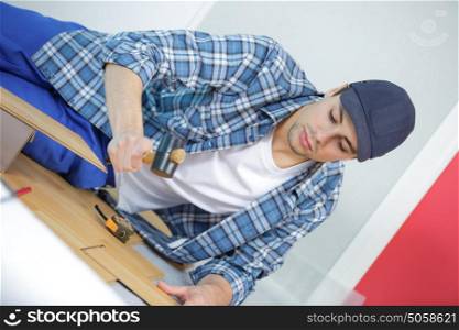 repair building and home concept - male measuring wood flooring