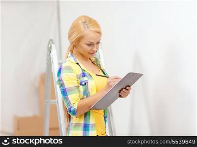 repair, building and home concept - smiling woman with clipboard