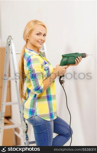 repair, building and home concept - smiling woman with electric drill making hole in wall