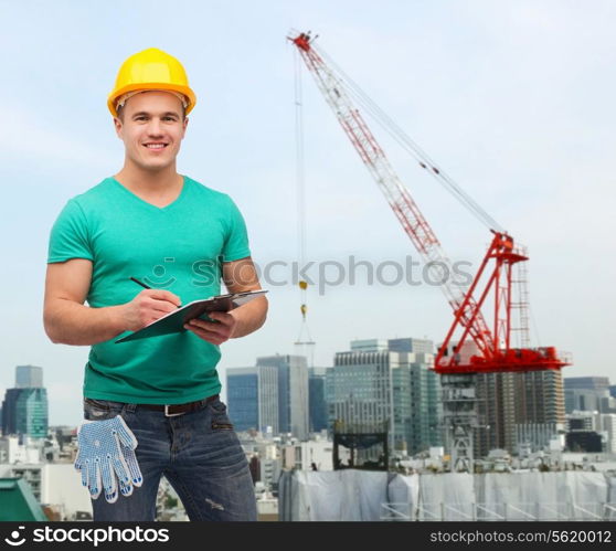 repair, building, construction and maintenance concept - smiling man in helmet with clipboard making notes