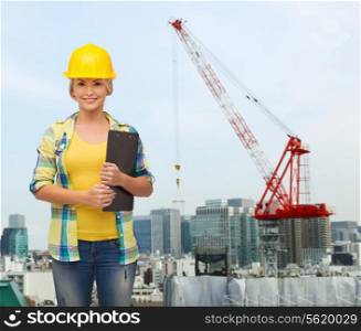 repair, building, construction and maintenance concept - smiling woman in helmet with clipboard