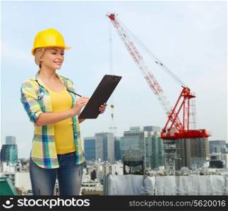repair, building, construction and maintenance concept - smiling woman in helmet with clipboard making notes