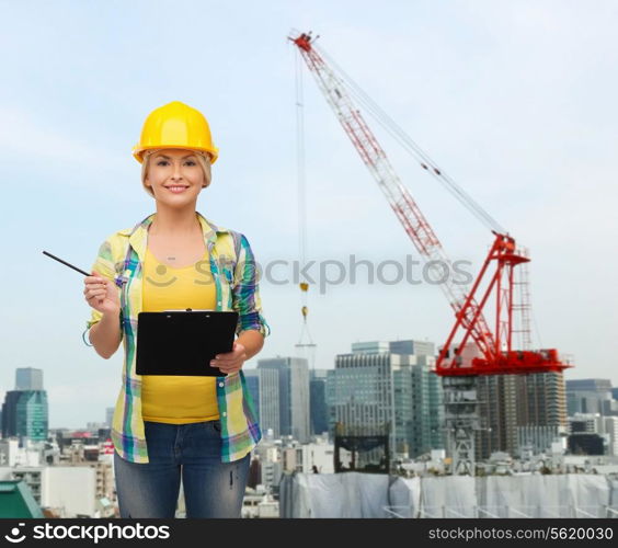 repair, building, construction and maintenance concept - smiling woman in helmet with clipboard making notes