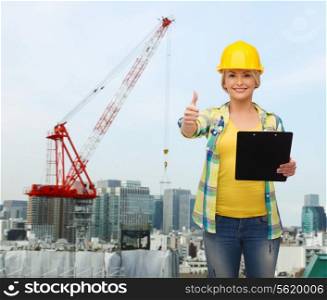 repair, building, construction and maintenance concept - smiling woman in helmet with clipboard showing thumbs up