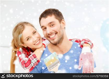 repair, building, love and people concept - smiling couple with paintbrush at home