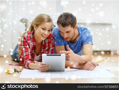 repair, building, renovation, technology and people concept - smiling couple with blueprint looking at tablet pc at home