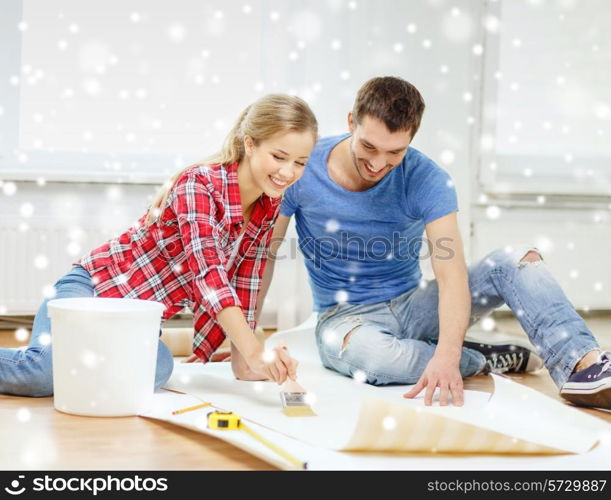 repair, building, teamwork and home concept - smiling couple smearing wallpaper with glue