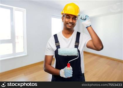 repair, construction and building concept - happy smiling indian builder or painter in helmet with paint roller over empty room background. happy indian painter or builder with paint roller