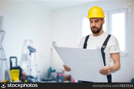 repair, construction and building concept - male worker or builder in helmet with blueprint over room with equipment on background. male worker or builder in helmet with blueprint