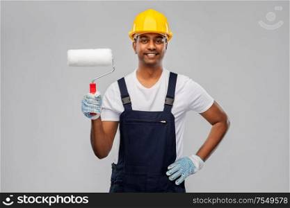 repair, construction and building - happy smiling indian builder or painter in helmet with paint roller over grey background. happy indian painter or builder with paint roller