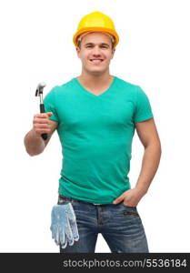 repair, construction and maintenance concept - smiling male manual worker in protective helmet with hammer