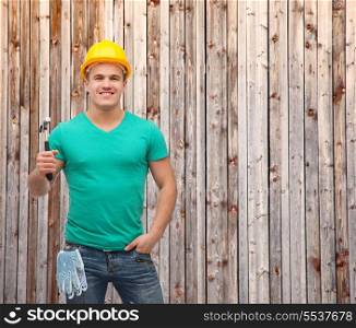 repair, construction and maintenance concept - smiling male manual worker in protective helmet with hammer