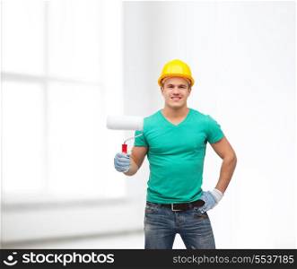repair, construction and maintenance concept - smiling male manual worker in protective helmet with paint roller