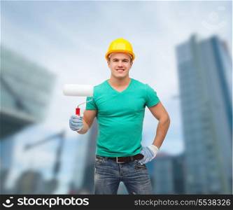 repair, construction and maintenance concept - smiling male manual worker in protective helmet with paint roller