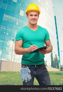 repair, construction and maintenance concept - smiling man in helmet with clipboard