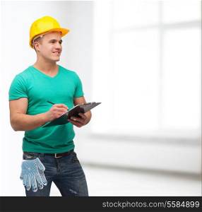 repair, construction and maintenance concept - smiling man in helmet with clipboard