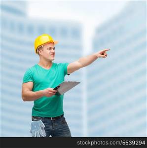 repair, construction and maintenance concept - smiling man in helmet with clipboard pointing finger
