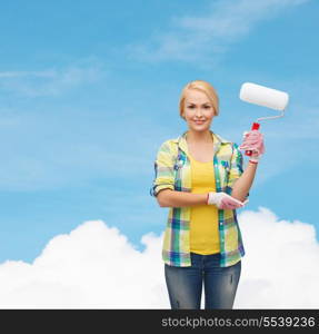 repair, construction and maintenance concept - smiling woman in gloves with paint roller