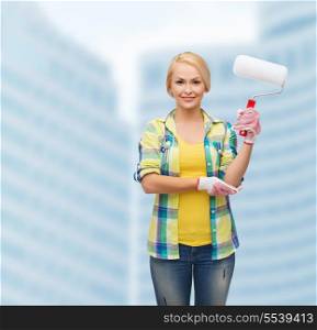 repair, construction and maintenance concept - smiling woman in gloves with paint roller