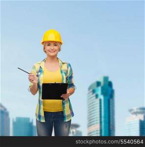 repair, construction and maintenance concept - smiling woman in helmet with clipboard