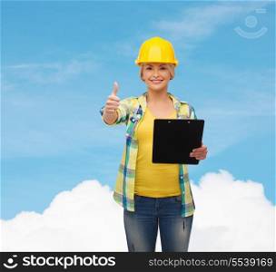 repair, construction and maintenance concept - smiling woman in helmet with clipboard showing thumbs up