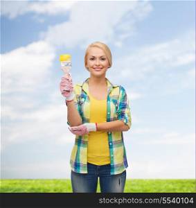 repair, construction and maintenance concept - smiling woman with paintbrush