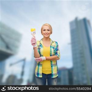 repair, construction and maintenance concept - smiling woman with paintbrush