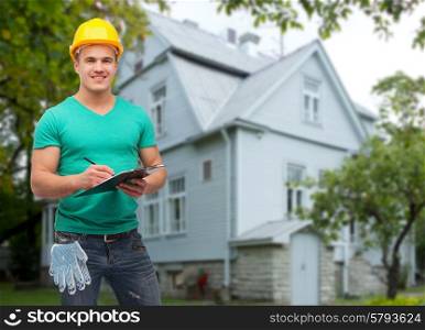 repair, construction, people, building and maintenance concept - smiling male manual worker in protective helmet taking notes to clipboard over house background