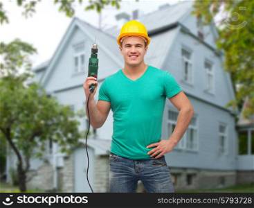 repair, construction, people, building and maintenance concept - smiling male manual worker in protective helmet holding electric drill over house background