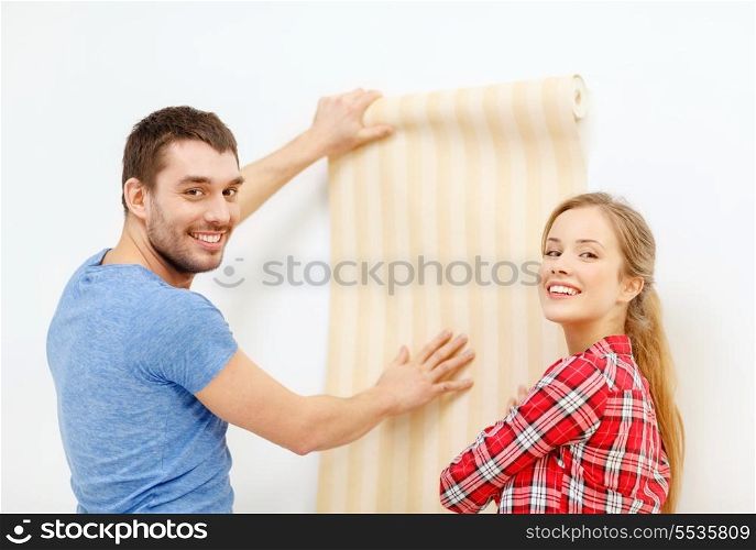 repair, interior design, building, renovation and home concept - smiling couple choosing wallpaper for new home