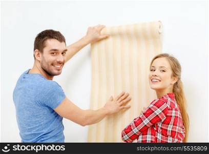 repair, interior design, building, renovation and home concept - smiling couple choosing wallpaper for new home
