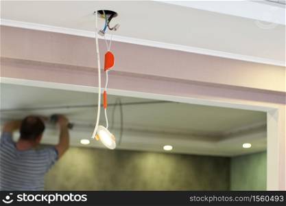 Repair of ceiling lamp. Working scene.