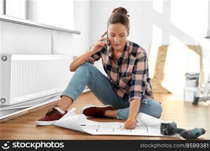 repair, people and real estate concept - woman with blueprint and pencil sitting on floor at home and calling on smartphone. woman with blueprint calling on smartphone at home