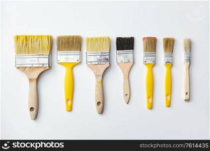 repair, renovation and painting concept - different size paint brushes on white background. different size paint brushes on white background