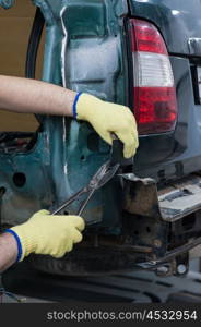 Repairing automotive body. Repairing automotive body closeup photo