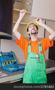 Repairman assembling the furniture at kitchen