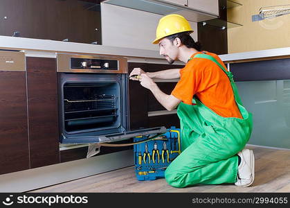 Repairman assembling the furniture at kitchen