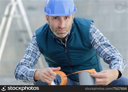 repairman builder holds a tape