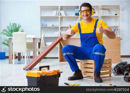 Repairman carpenter working with wooden plank planks