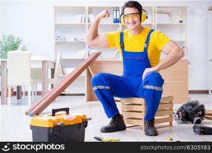 Repairman carpenter working with wooden plank planks
