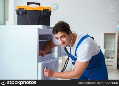 Repairman contractor repairing fridge in DIY concept