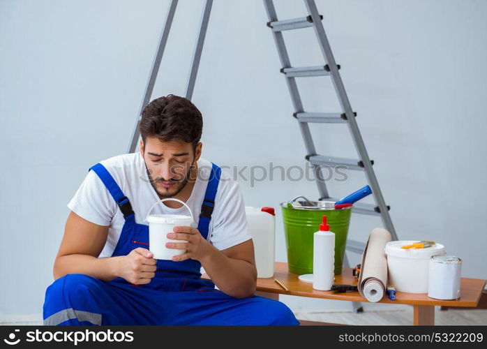 Repairman doing renovation repair in the house with paper wallpa. Repairman doing renovation repair in the house with paper wallpaper