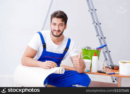 Repairman doing renovation repair in the house with paper wallpa. Repairman doing renovation repair in the house with paper wallpaper