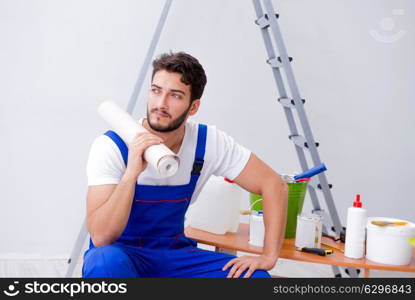 Repairman doing renovation repair in the house with paper wallpa. Repairman doing renovation repair in the house with paper wallpaper