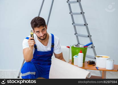 Repairman doing renovation repair in the house with paper wallpa. Repairman doing renovation repair in the house with paper wallpaper