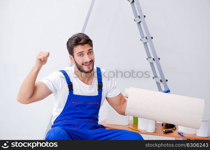 Repairman doing renovation repair in the house with paper wallpa. Repairman doing renovation repair in the house with paper wallpaper