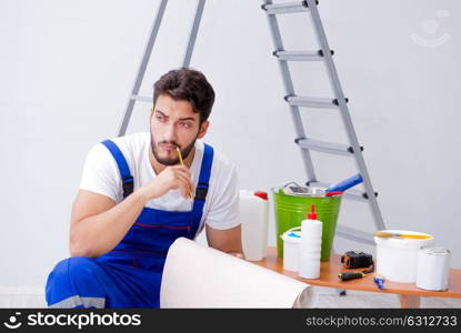 Repairman doing renovation repair in the house with paper wallpa. Repairman doing renovation repair in the house with paper wallpaper